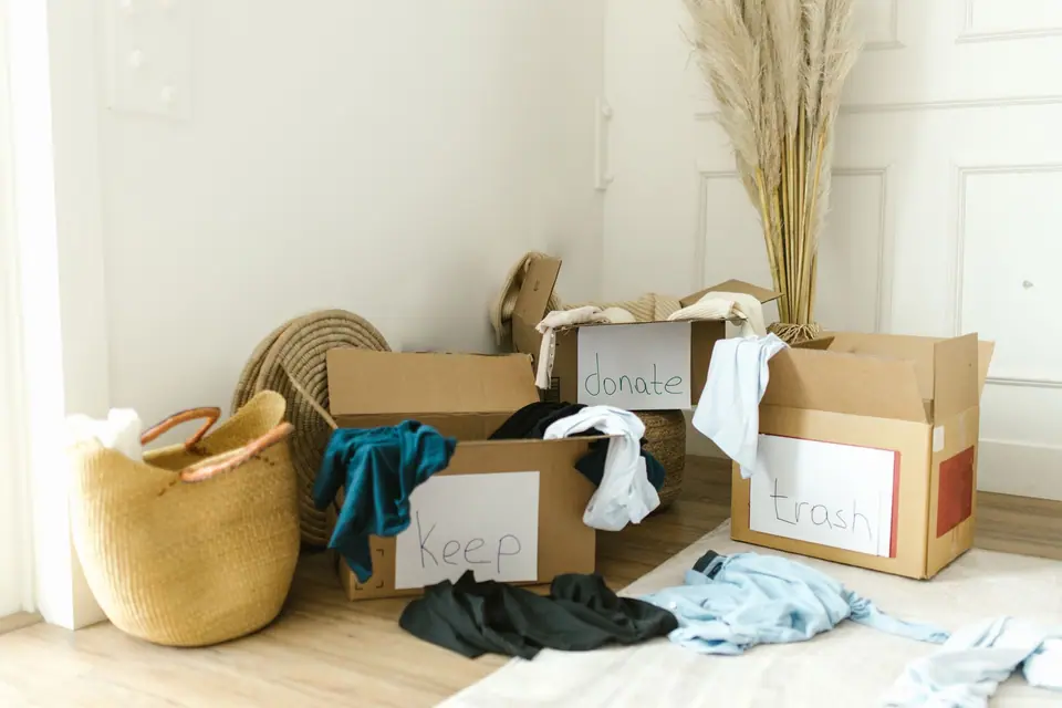 Boxes marked keep, donate and trash in a sunny room (representative photo)